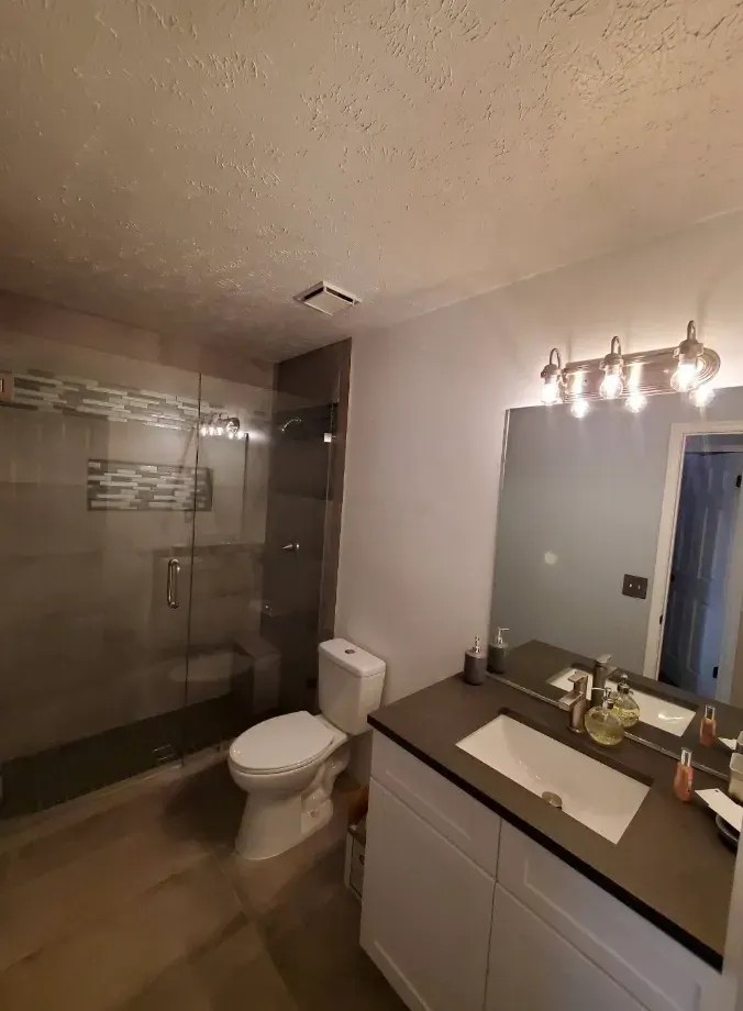 Remodeled bathroom with a new vanity, tile, and modern finishes