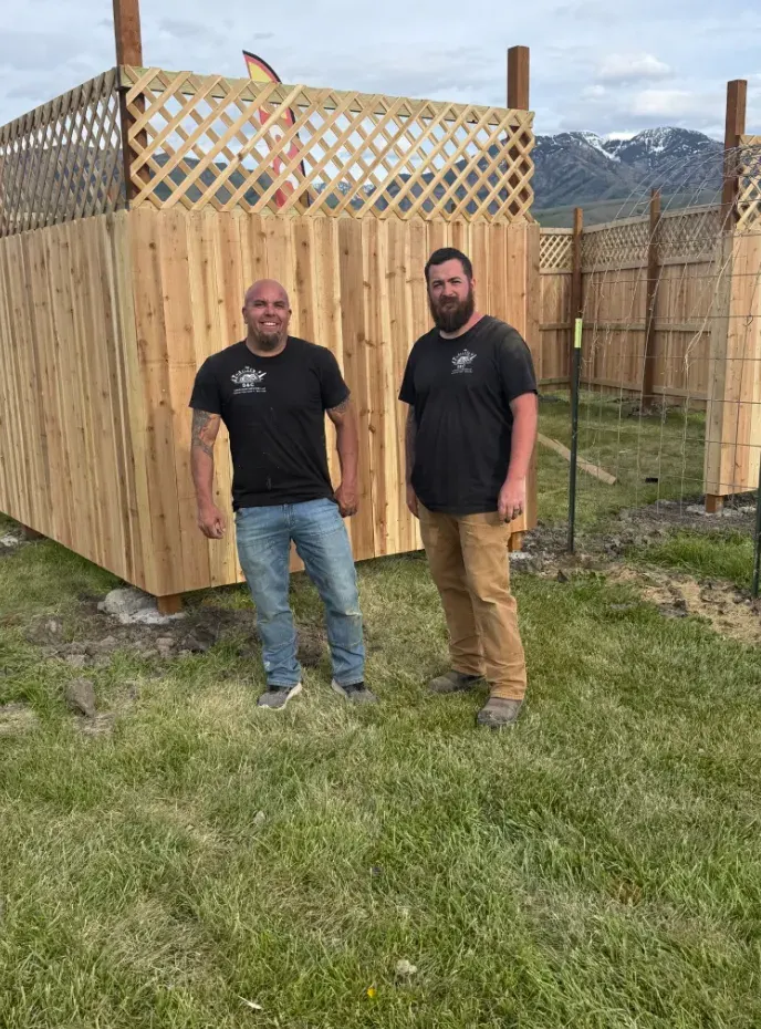Seth and Collin, owners of S&C Handyman Services, in front of a completed cedar fence